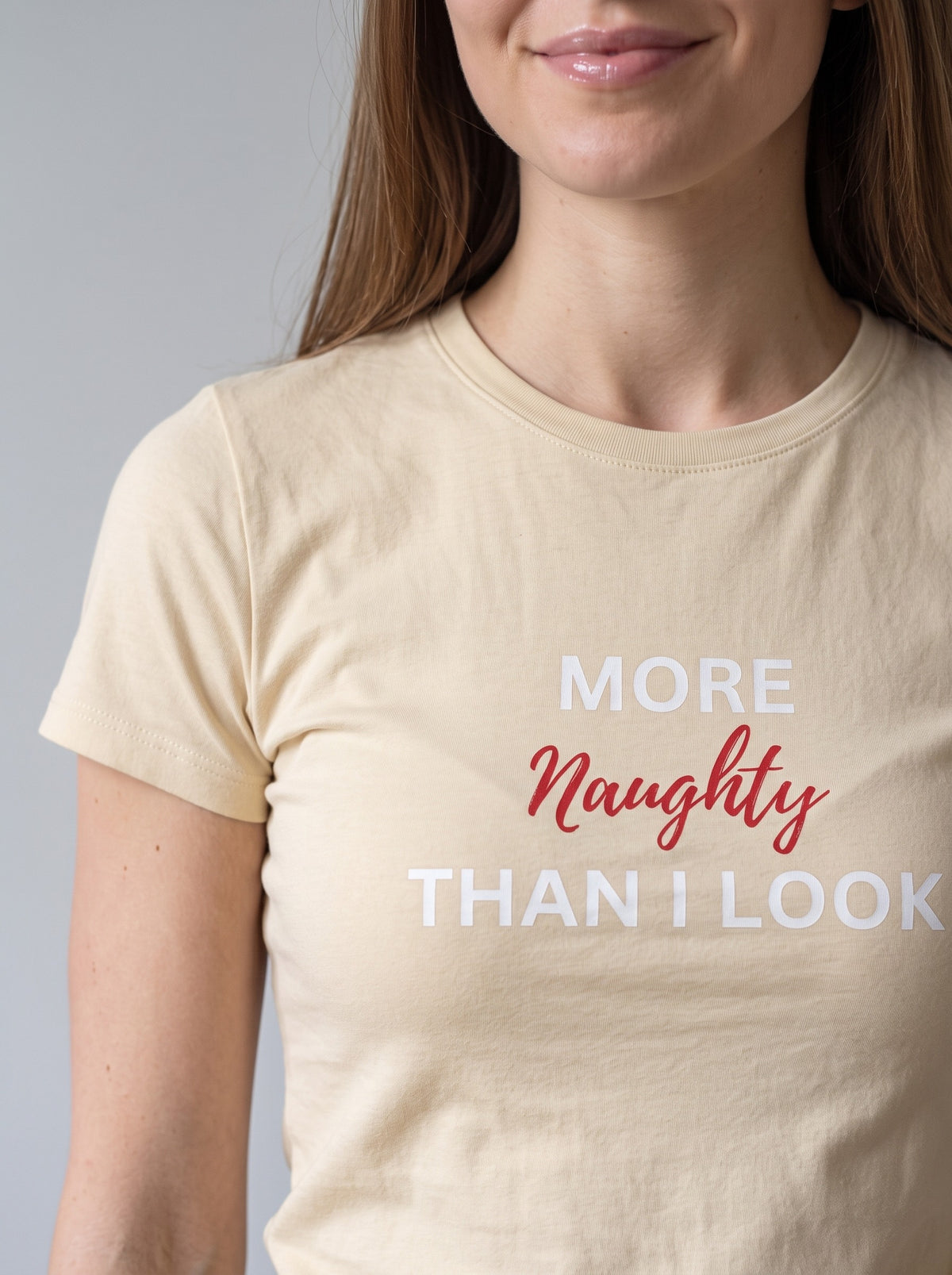 More Naughty Than I Look tee in Soft Cream — angled close-up [kk-studio]