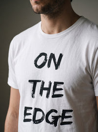 On the Edge tee in White — angled close-up [kk-studio]