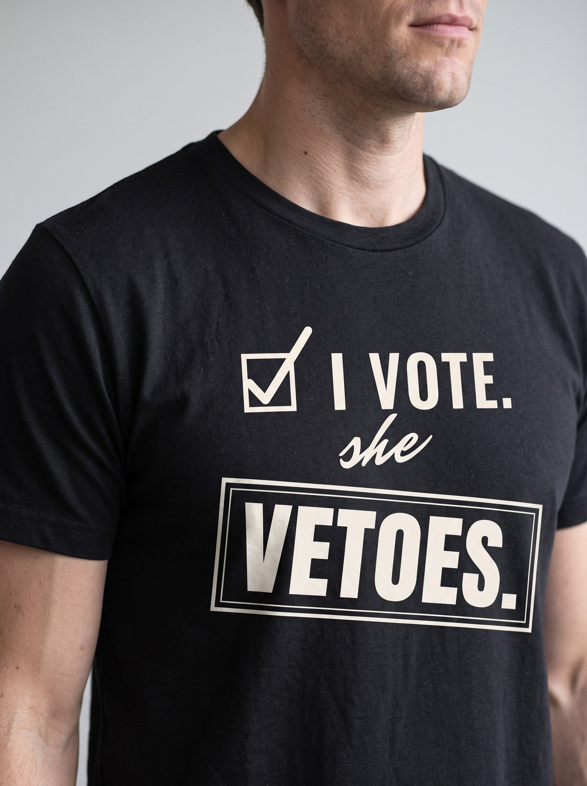 I Vote. She Vetoes. tee in Black — angled close-up [kk-studio]