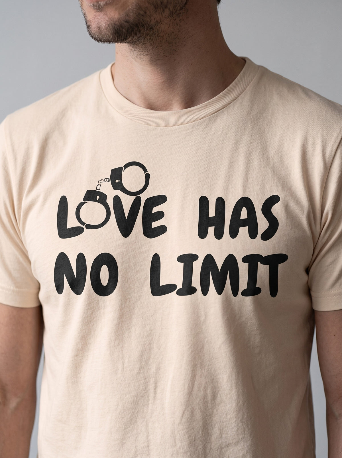 Love Has No Limit (His) tee in Soft Cream — angled close-up [kk-studio]