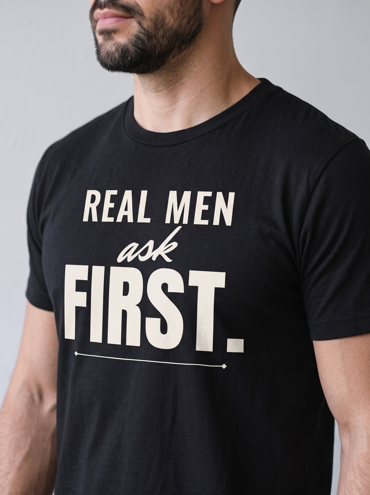 Real Men Ask First tee in Black — angled close-up [kk-studio]