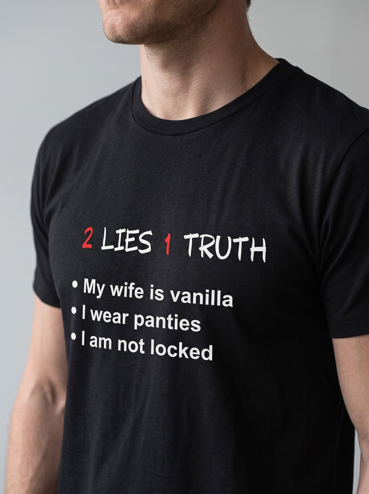 2 Lies, 1 Truth tee in Black — angled close-up [kk-studio]
