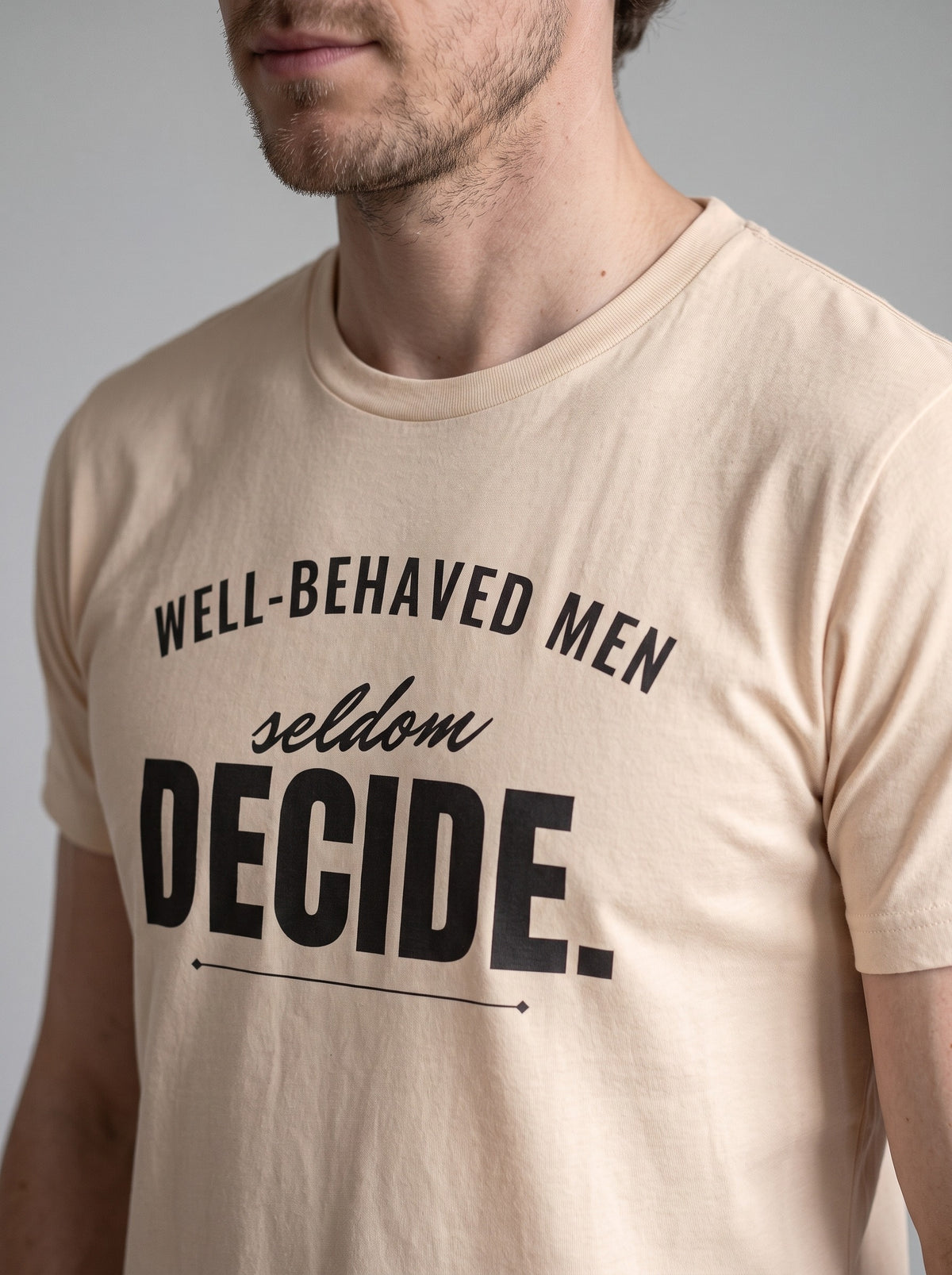 Well-Behaved Men Seldom Decide tee in Soft Cream — angled close-up [kk-studio]