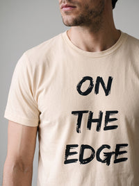 On the Edge tee in Soft Cream — angled close-up [kk-studio]